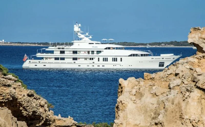 a white boat on a body of water aboard ROMA Yacht for Sale