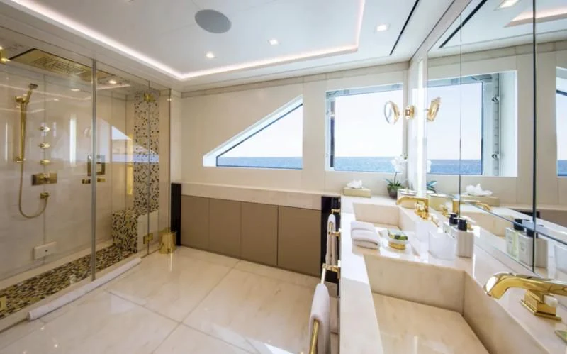 a bathroom with a glass shower aboard ROMA Yacht for Sale