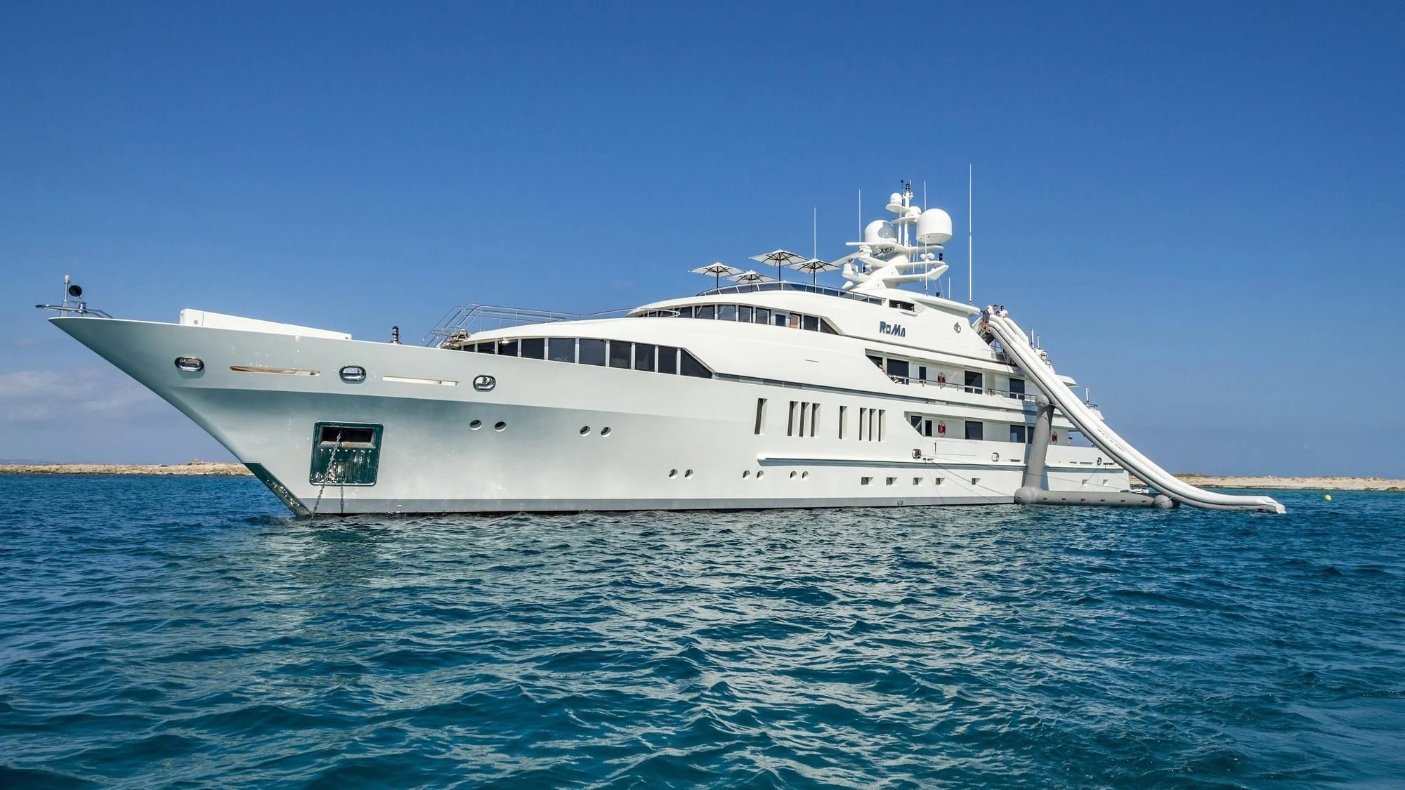 a white yacht in the water aboard ROMA Yacht for Sale