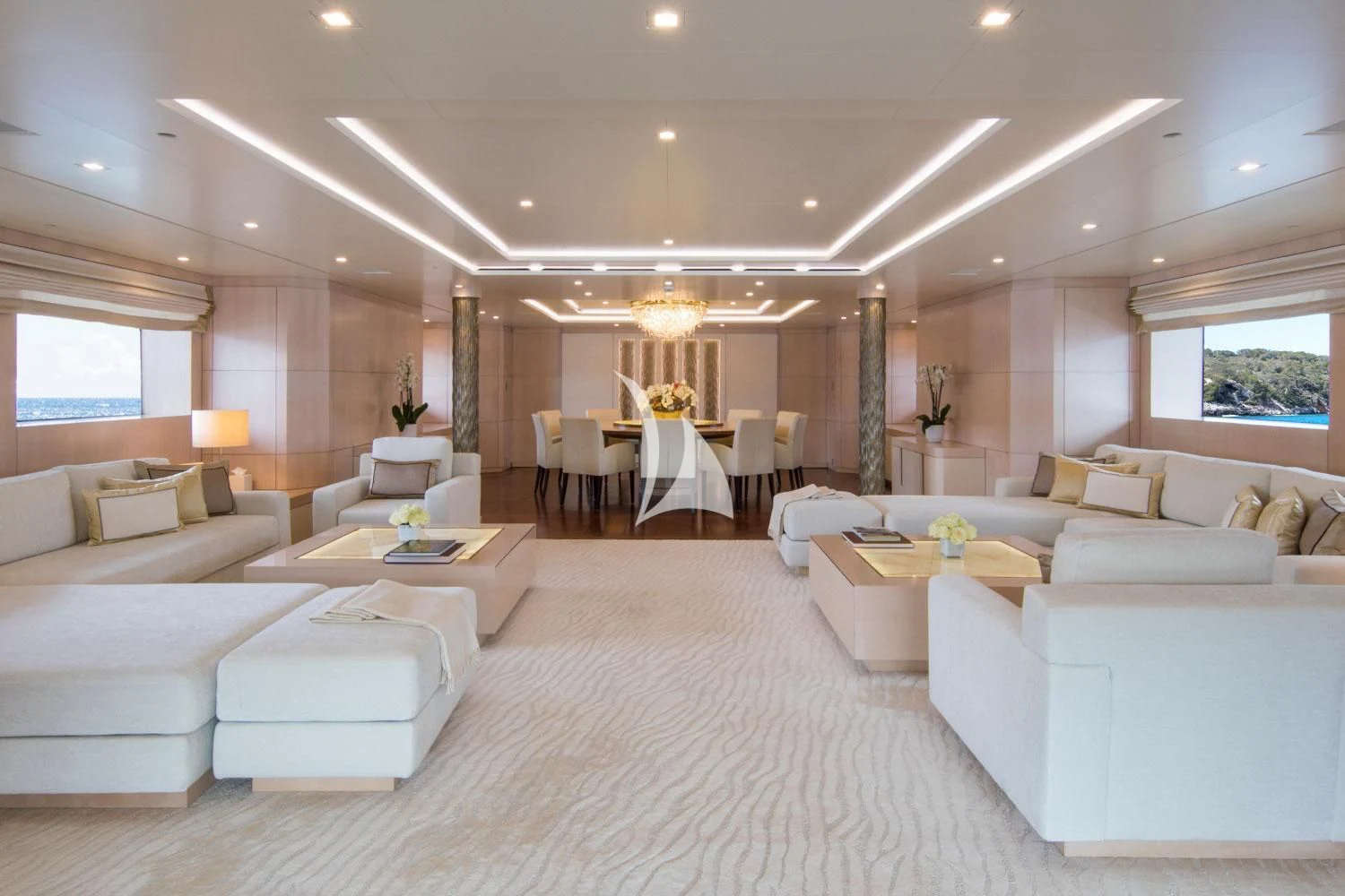 a large living room with white furniture aboard ROMA Yacht for Sale