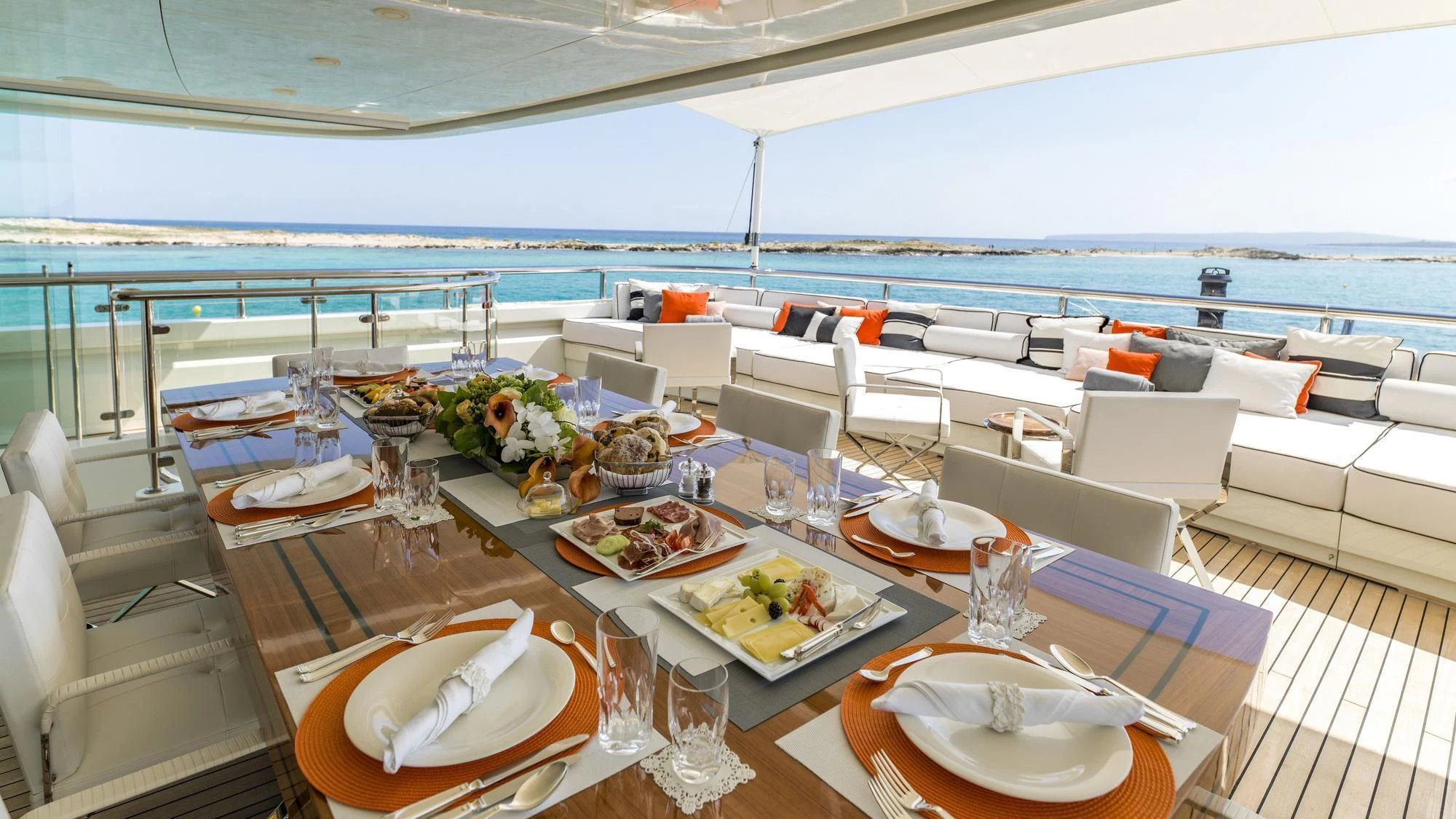 a table with plates and food on it aboard ROMA Yacht for Sale