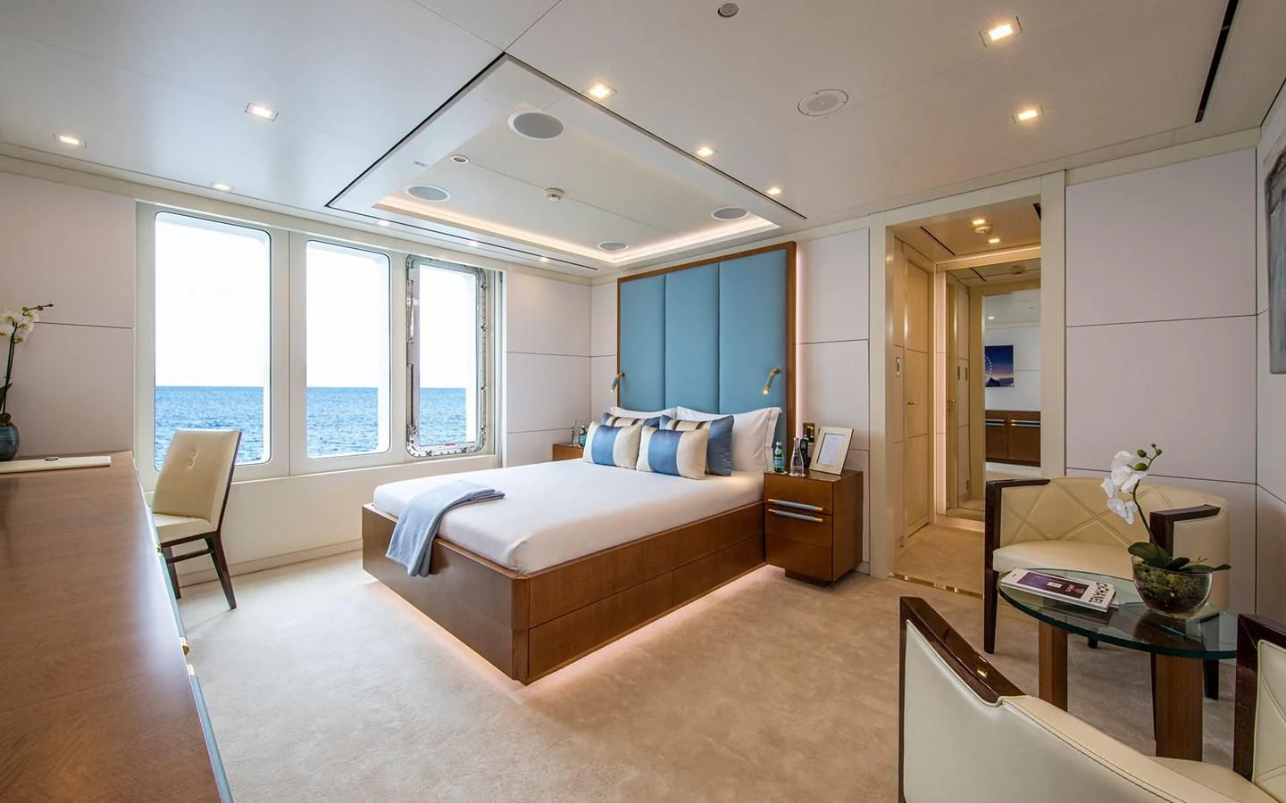 a bedroom with a bed and a table aboard ROMA Yacht for Sale