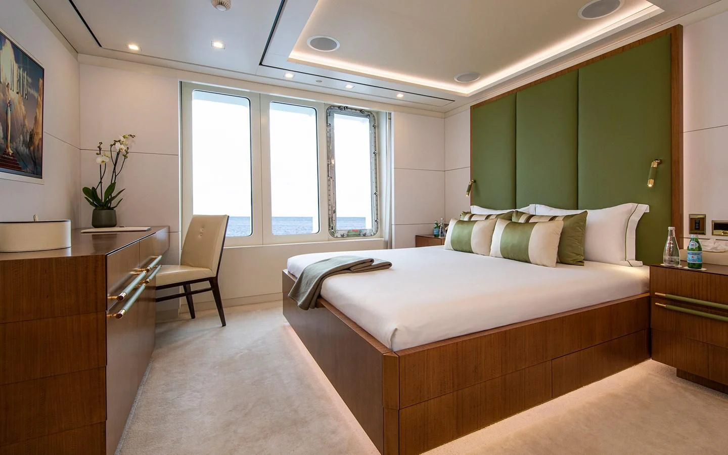 a bedroom with green walls aboard ROMA Yacht for Sale