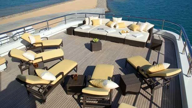 a room with a bed and a table on a boat aboard ROMA Yacht for Sale