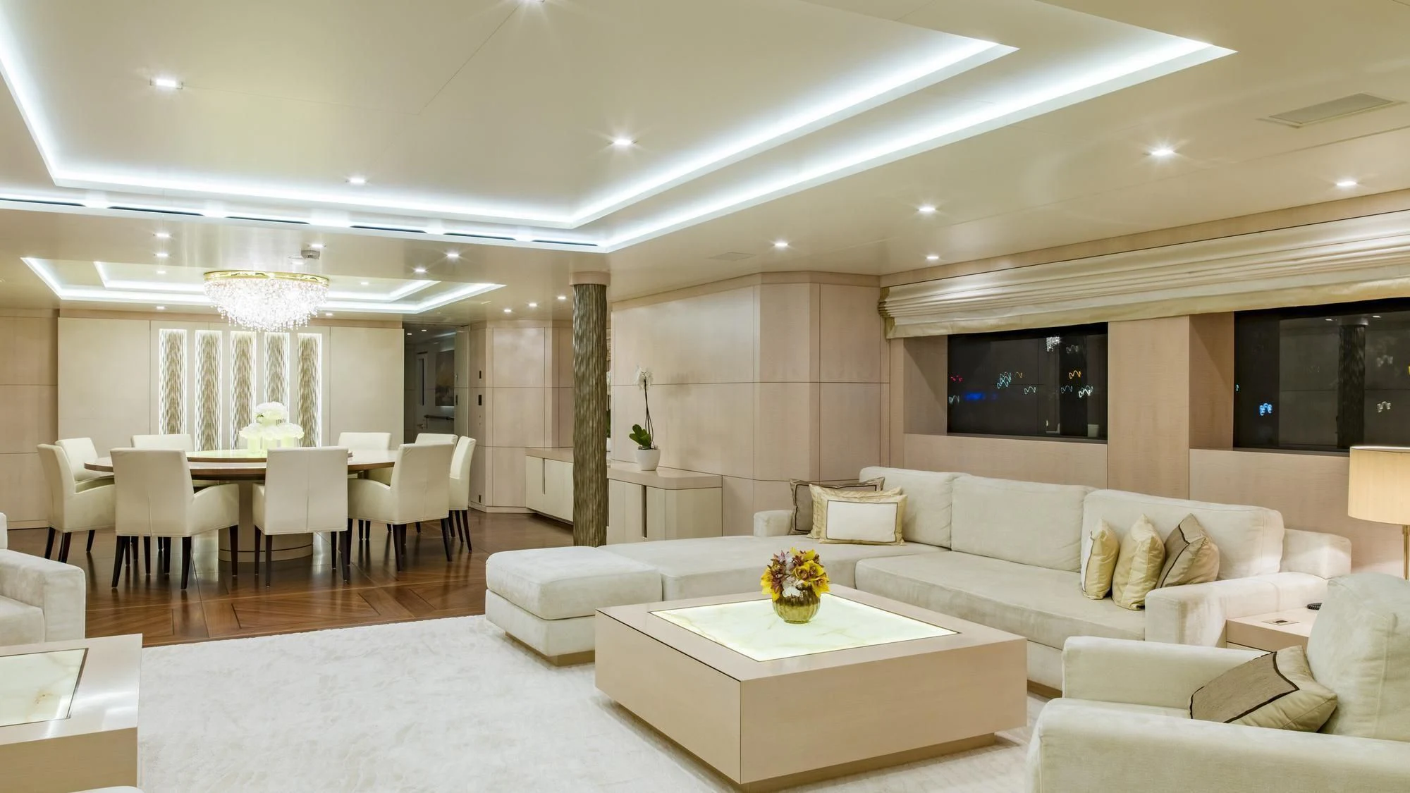 a living room with white furniture aboard ROMA Yacht for Sale