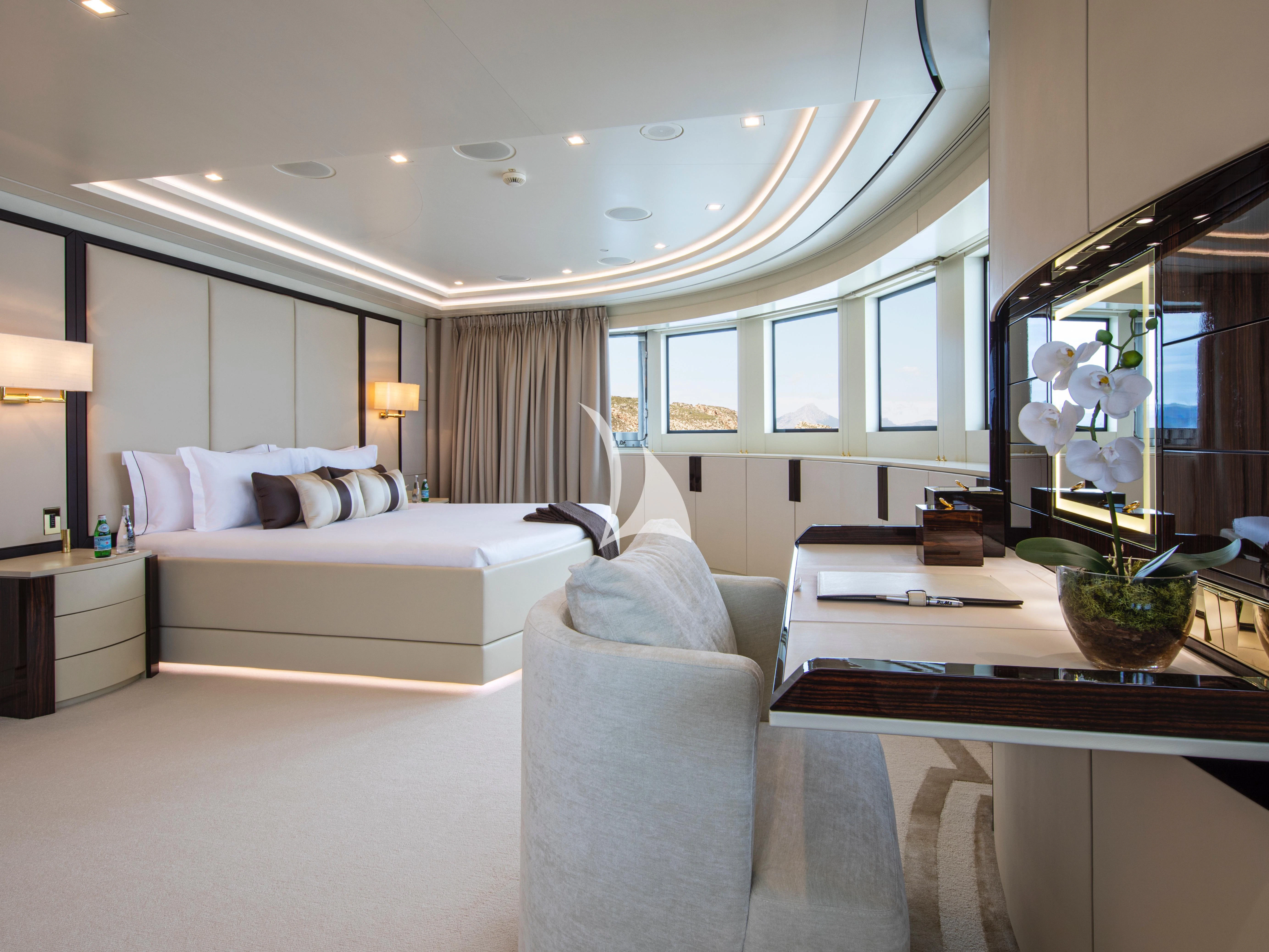 a large white bedroom with a large mirror aboard ROMA Yacht for Sale