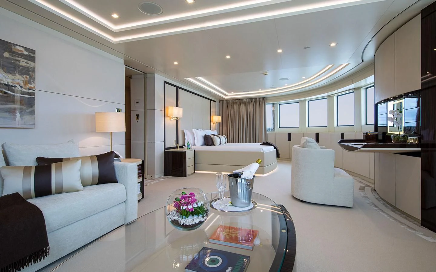 a living room with a large white sofa and a large mirror aboard ROMA Yacht for Sale
