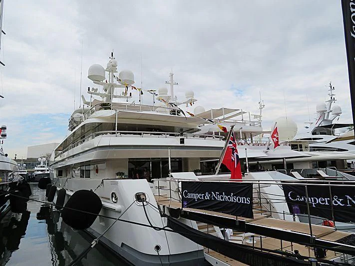 a large white boat with a red stripe on the front aboard ROMA Yacht for Sale