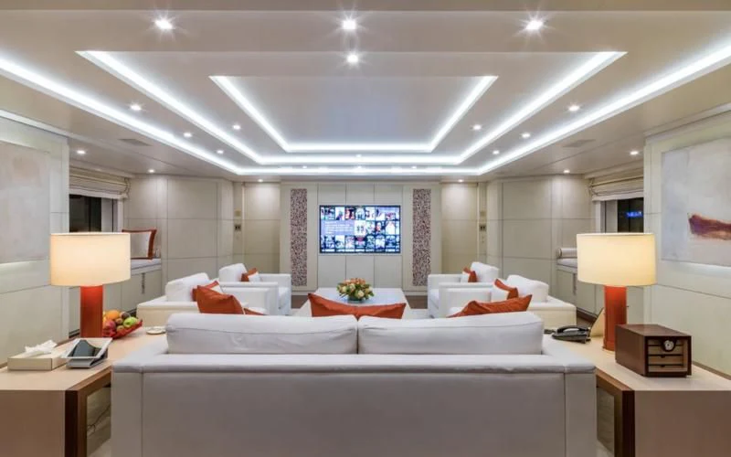 a bedroom with a bed and a table aboard ROMA Yacht for Sale