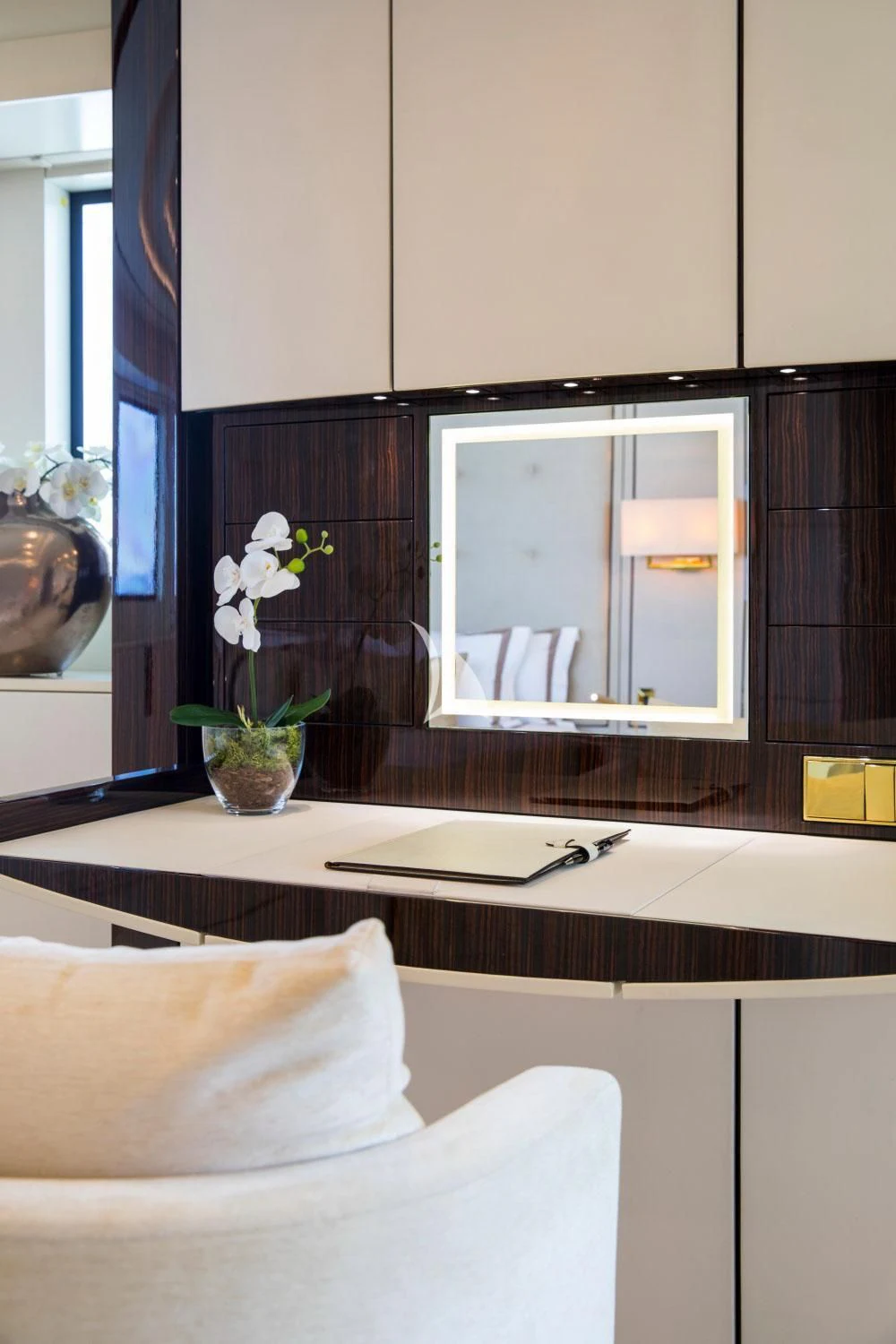 a room with a mirror and a table with a plant in it aboard ROMA Yacht for Sale