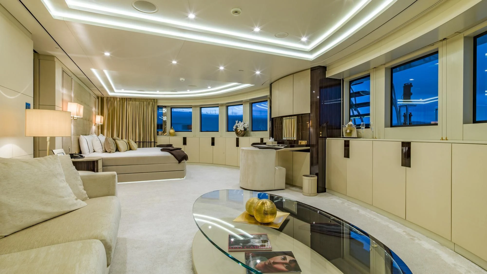 a living room with a large glass table and a large window aboard ROMA Yacht for Sale
