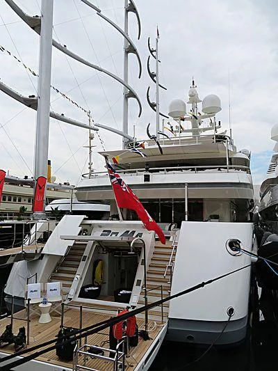 a large white boat with a red crane on the deck aboard ROMA Yacht for Sale