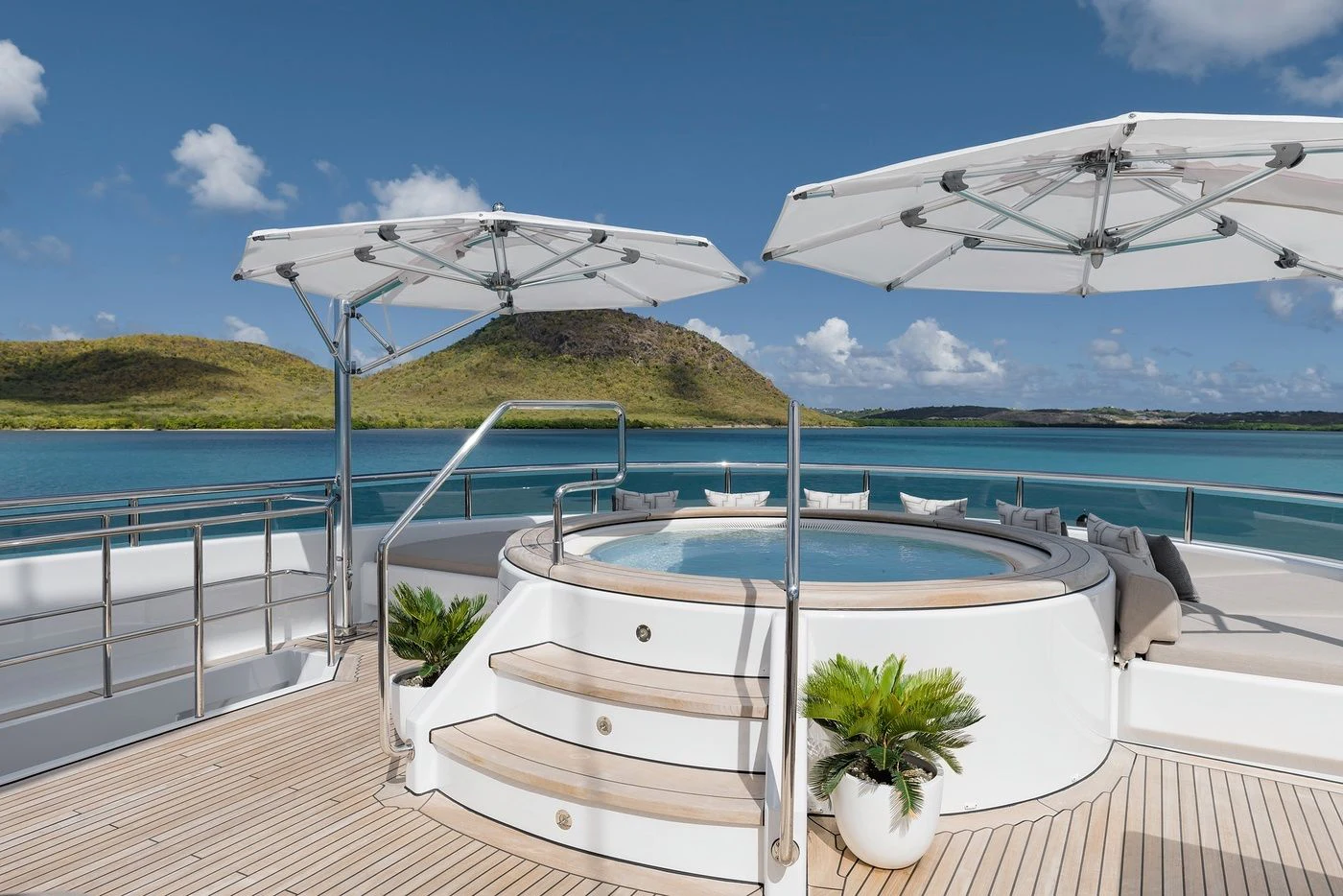 a white lounge chair on a deck overlooking a blue ocean aboard GLADIATOR Yacht for Sale