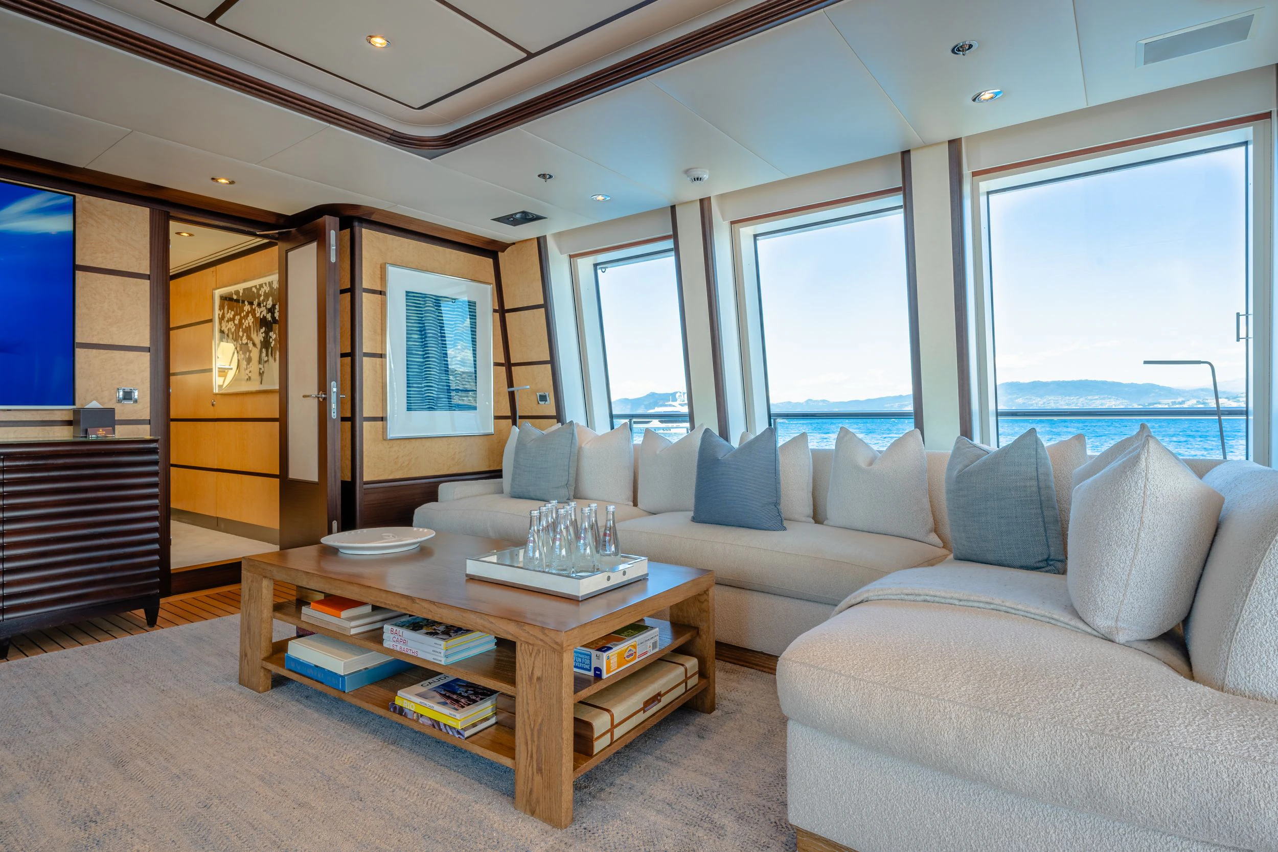 a living room with a couch and a coffee table aboard GLADIATOR Yacht for Sale