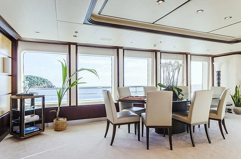 a room with tables and chairs aboard GLADIATOR Yacht for Sale