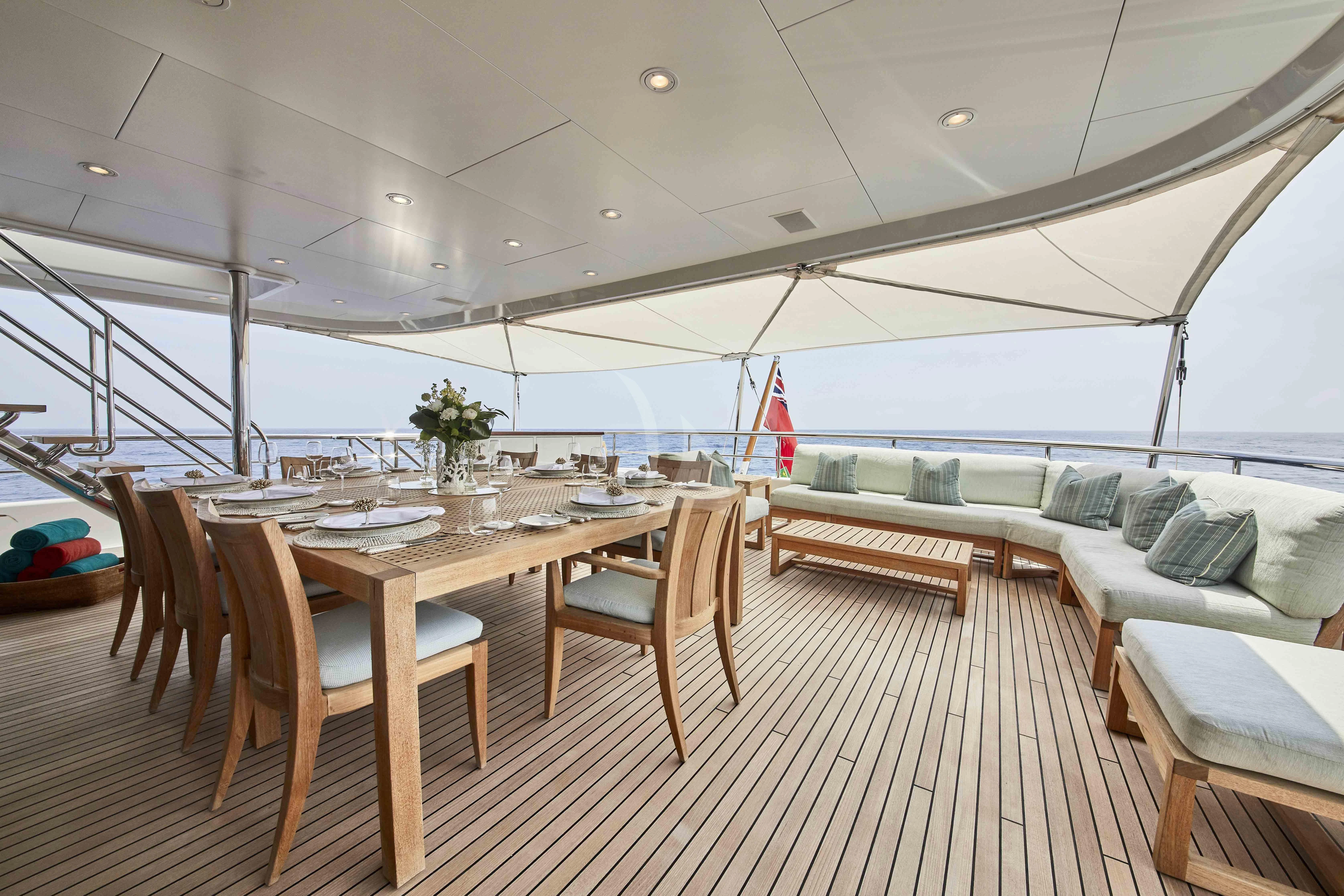 a large room with a table and chairs aboard GLADIATOR Yacht for Sale