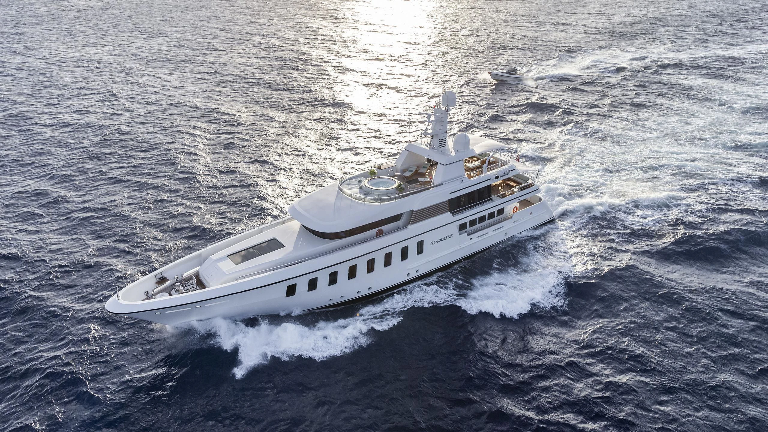a white yacht in the ocean aboard GLADIATOR Yacht for Sale