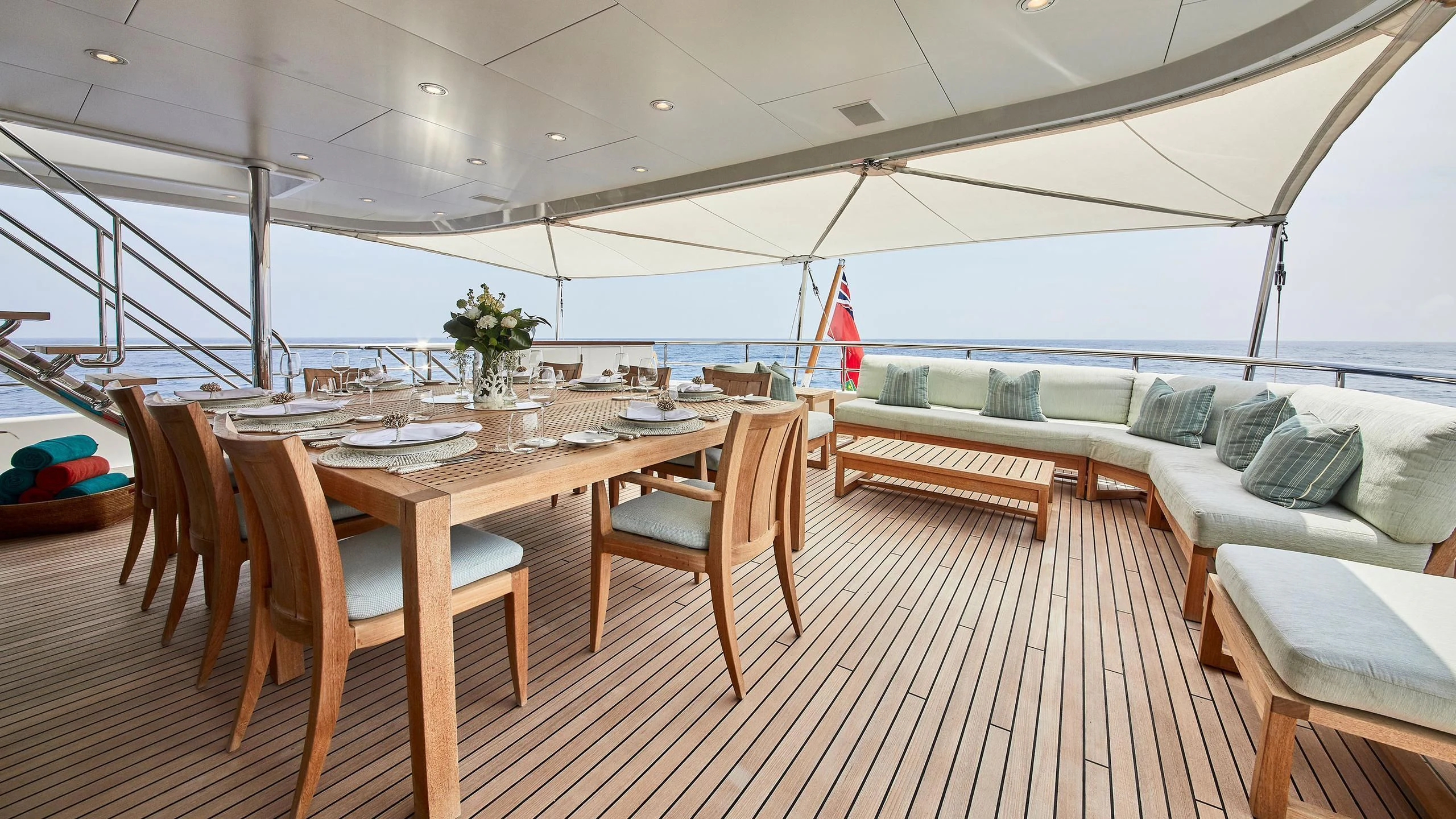 a table and chairs on a deck aboard GLADIATOR Yacht for Sale