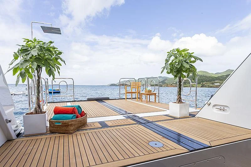 a deck with a view of the ocean and a beach aboard GLADIATOR Yacht for Sale
