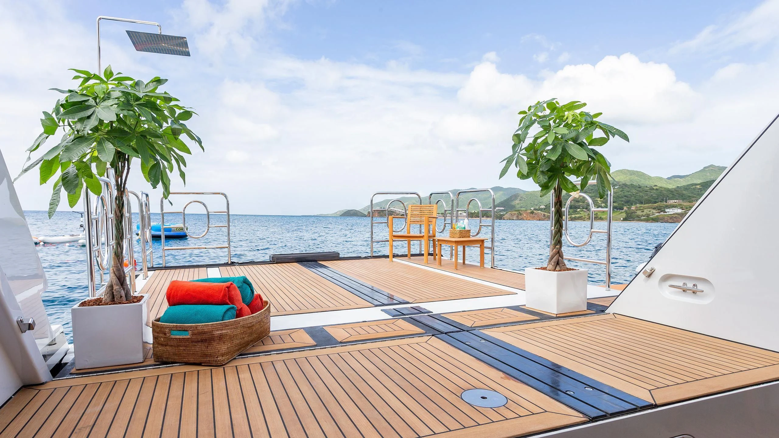 a deck with chairs and a tree on it by the water aboard GLADIATOR Yacht for Sale