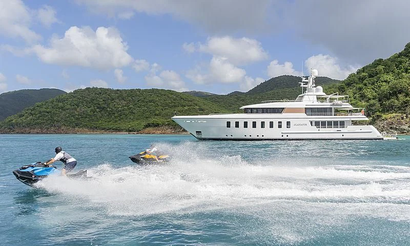 a person on a jet ski in the water next to a boat aboard GLADIATOR Yacht for Sale