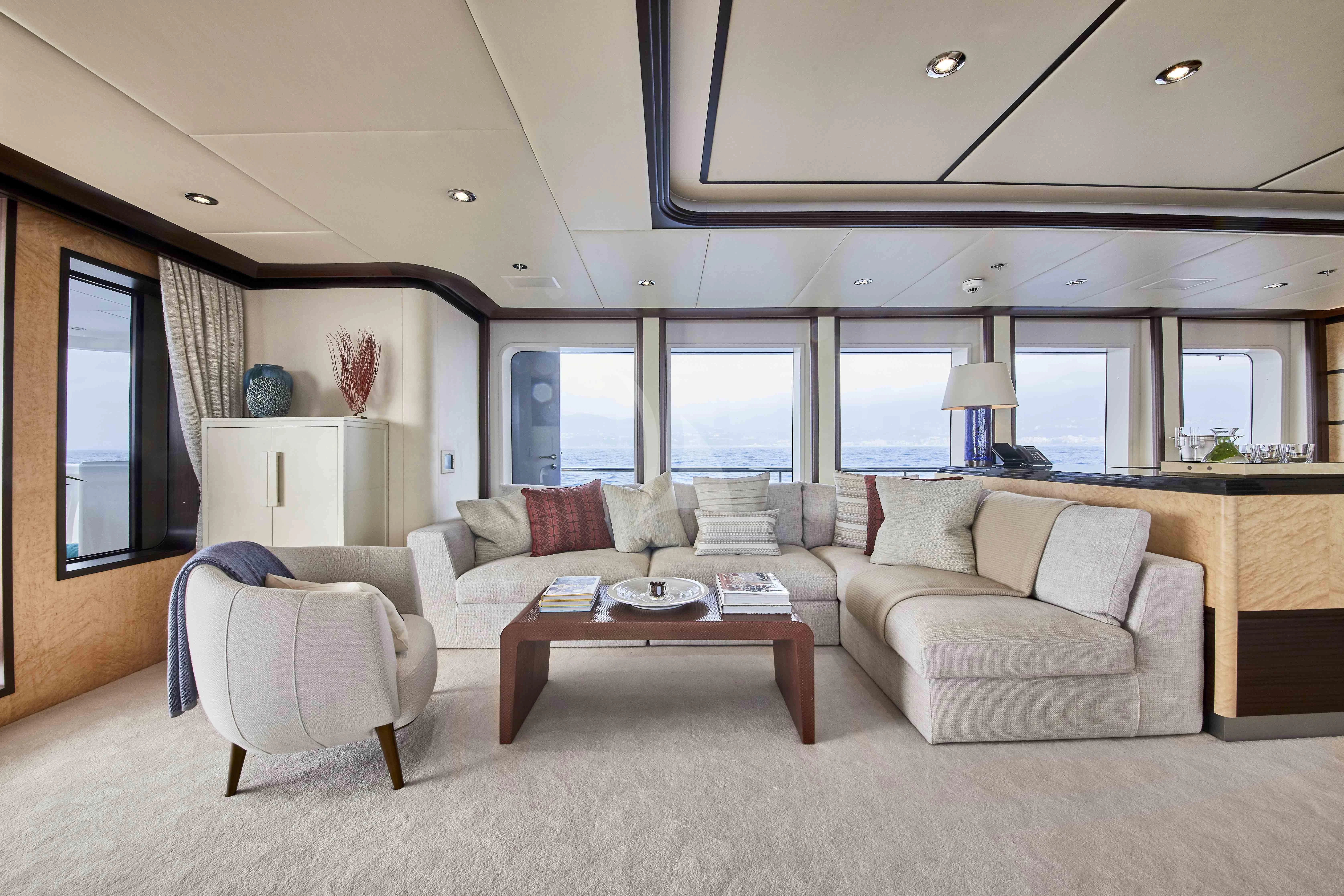 a living room with a couch and a coffee table aboard GLADIATOR Yacht for Sale