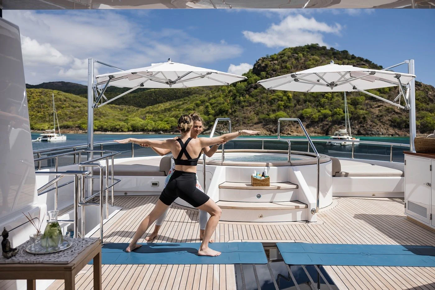 a person on a mat on a deck by a pool aboard GLADIATOR Yacht for Sale
