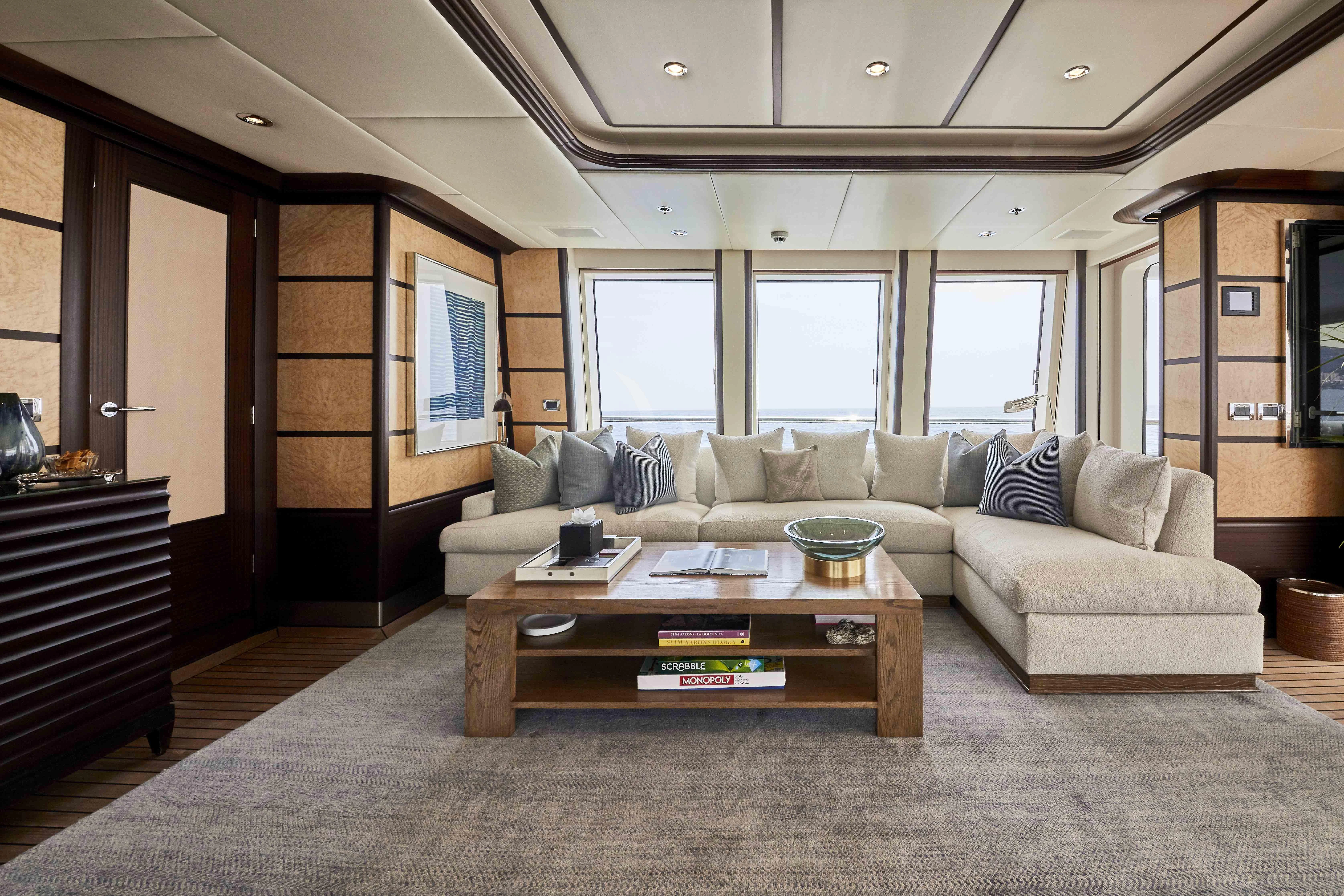 a living room with a couch and a coffee table aboard GLADIATOR Yacht for Sale