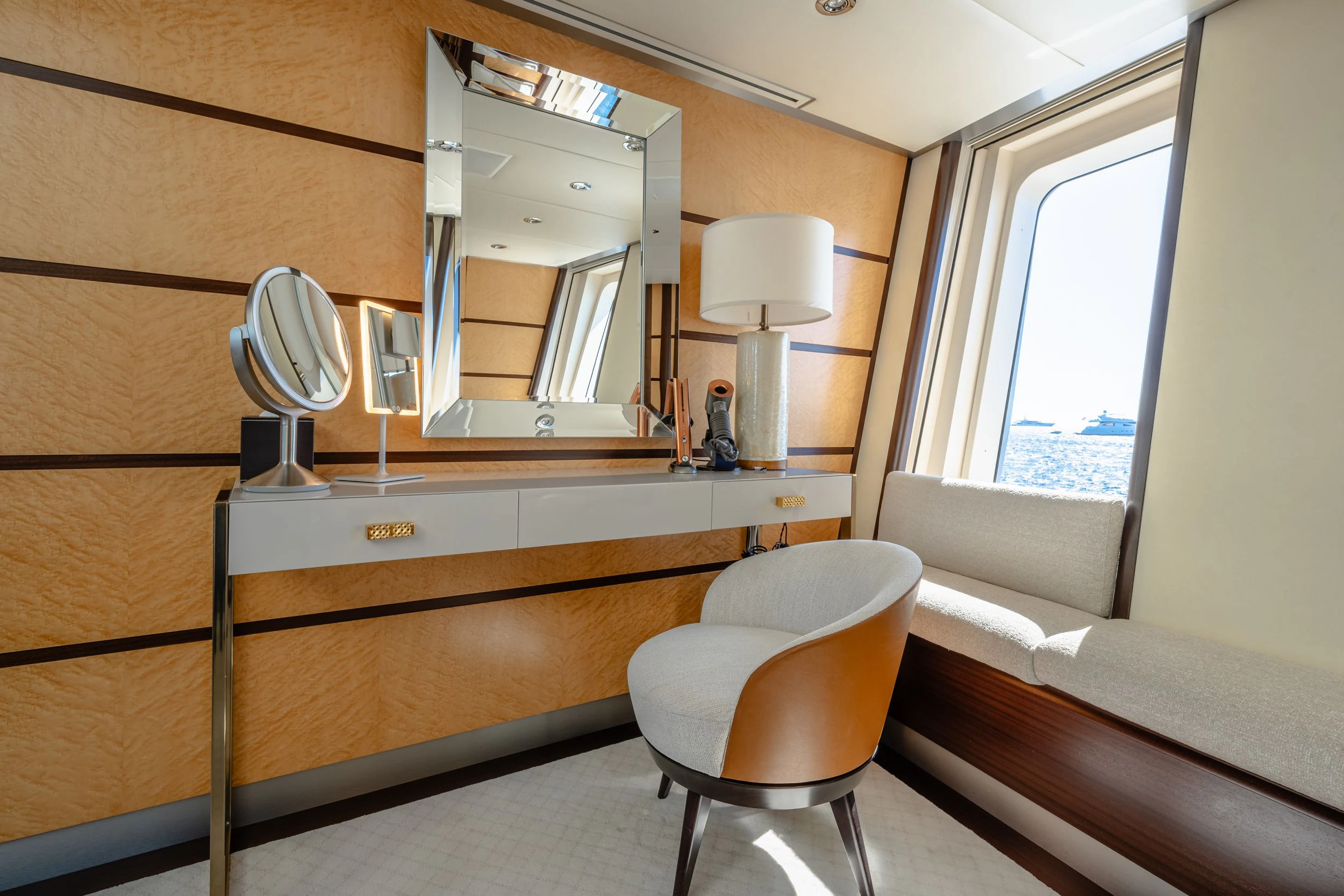 a room with a mirror and a chair aboard GLADIATOR Yacht for Sale