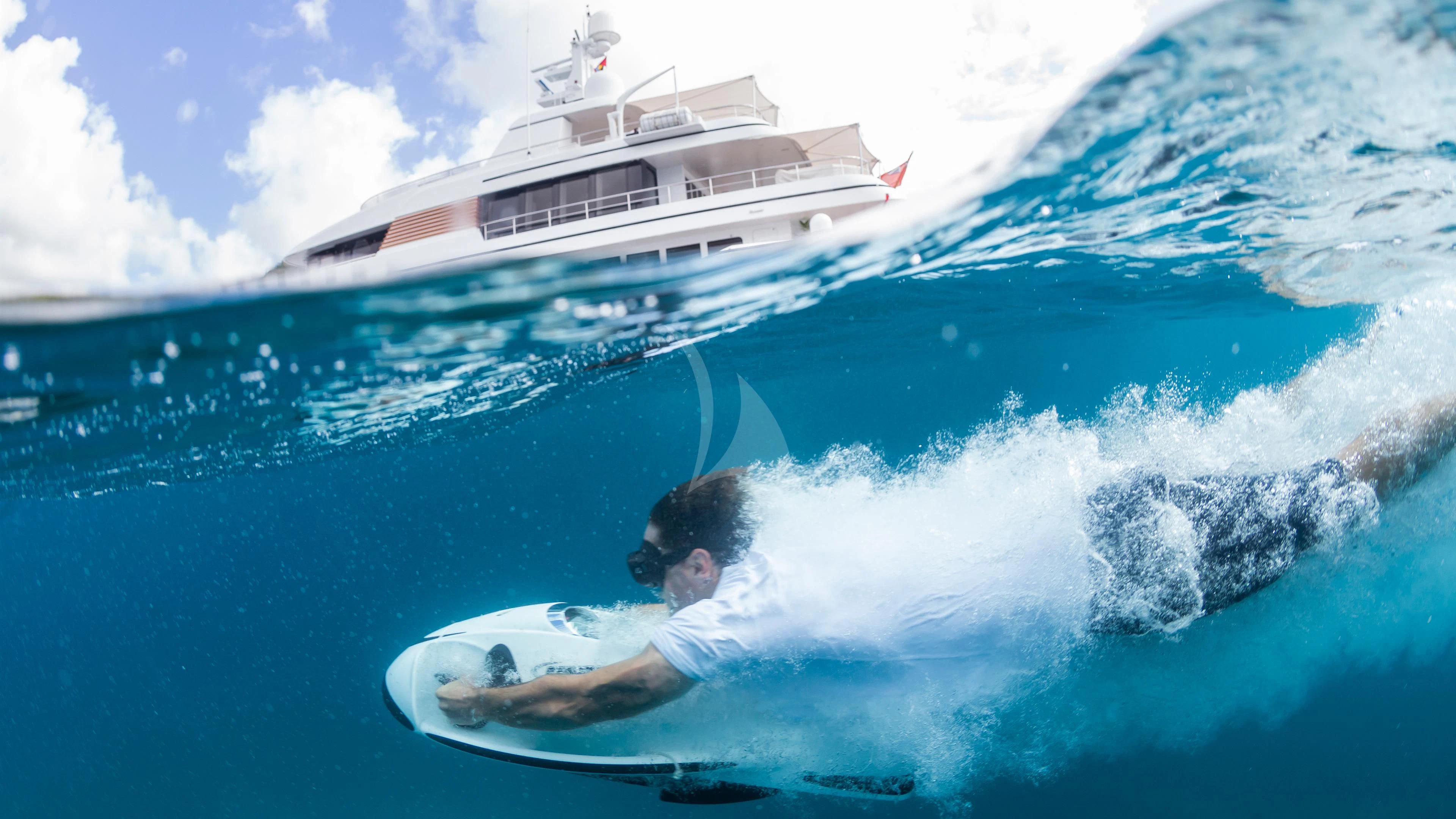 a man surfing on the waves aboard GLADIATOR Yacht for Sale