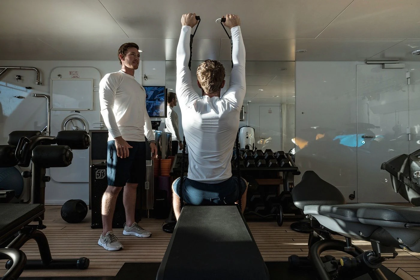 a person lifting weights in a gym aboard GLADIATOR Yacht for Sale