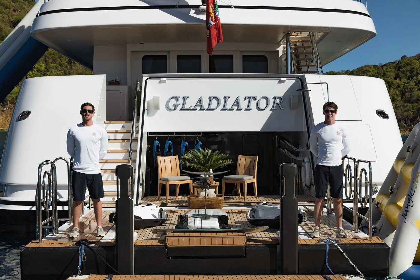 two men standing in front of a white tent aboard GLADIATOR Yacht for Sale