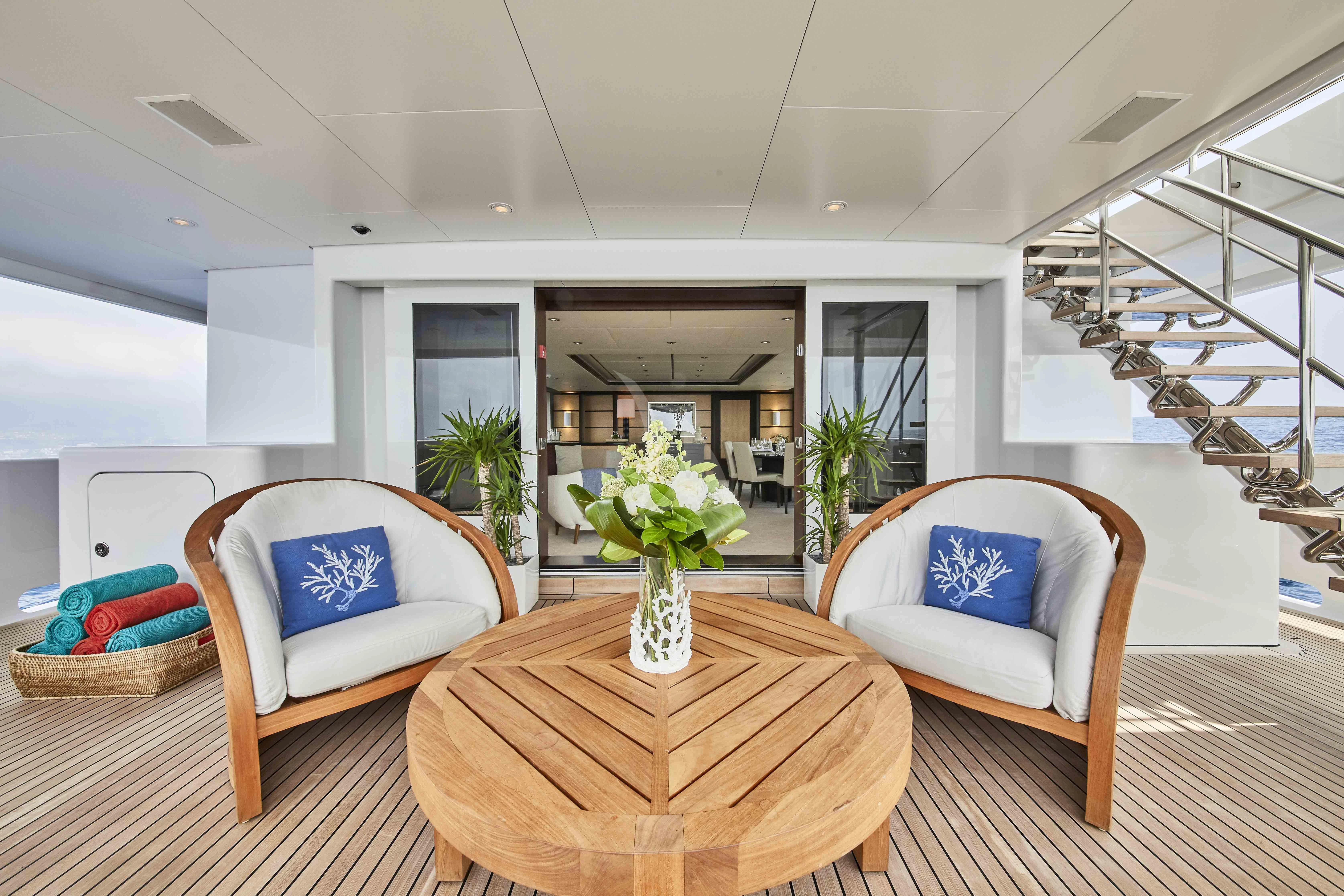 a living room with a table and chairs aboard GLADIATOR Yacht for Sale