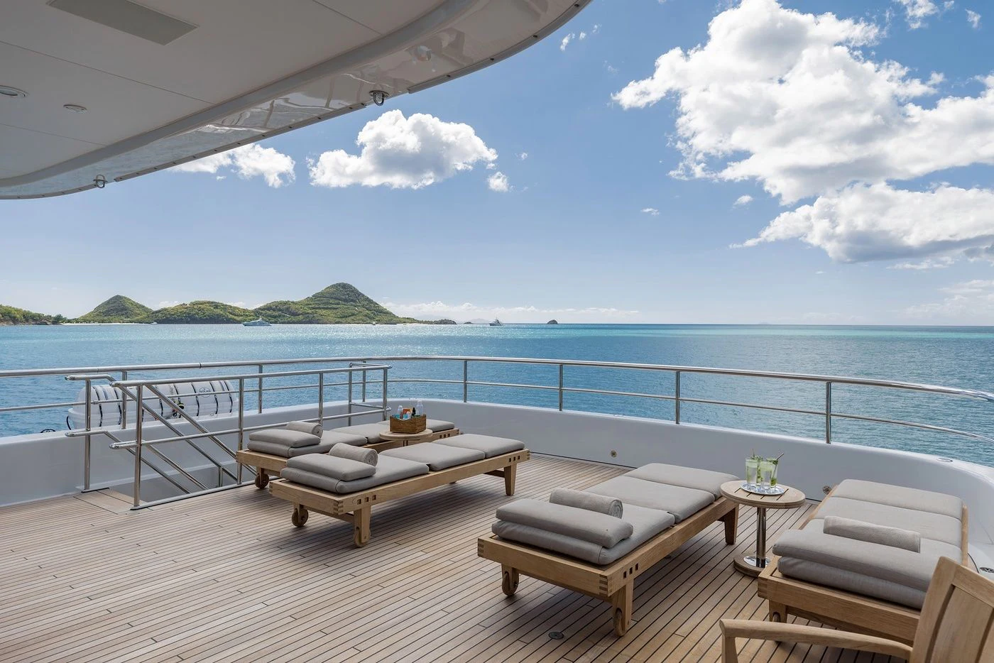 a table and chairs on a deck overlooking a body of water aboard GLADIATOR Yacht for Sale