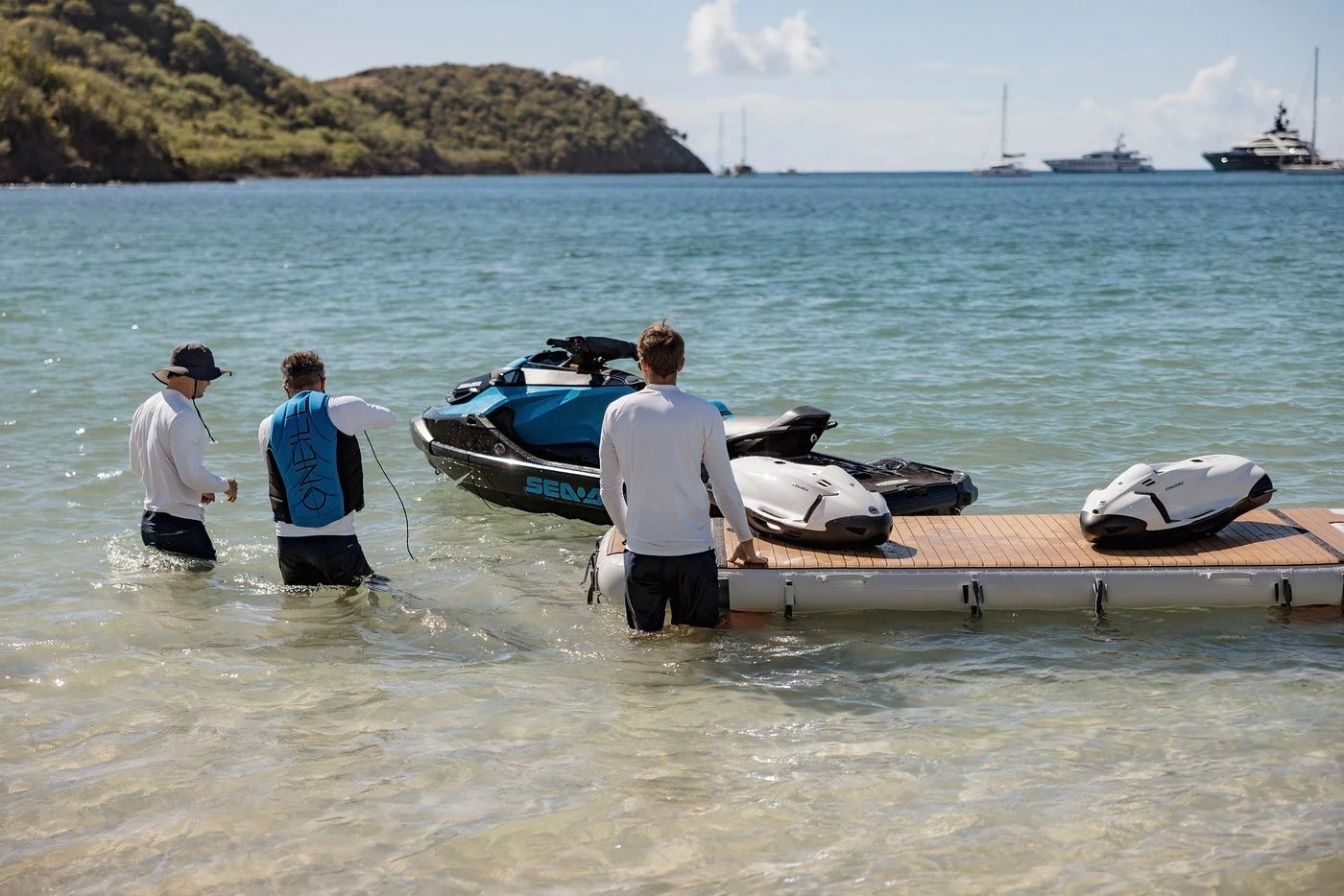 a group of men on a dock with a boat in the water aboard GLADIATOR Yacht for Sale