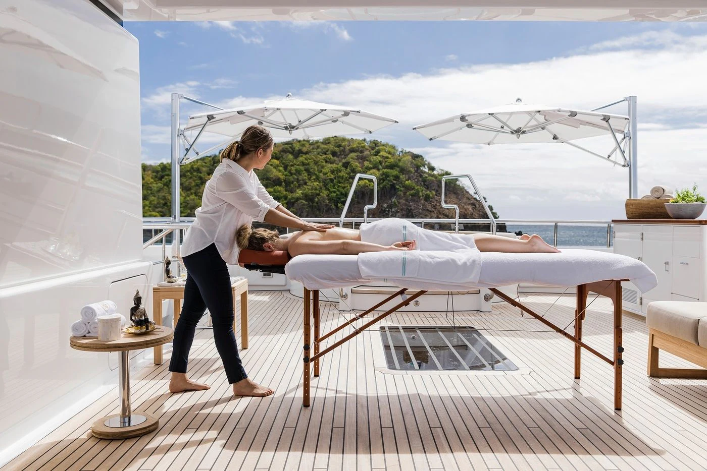 a man and a woman on a deck with a table and chairs aboard GLADIATOR Yacht for Sale