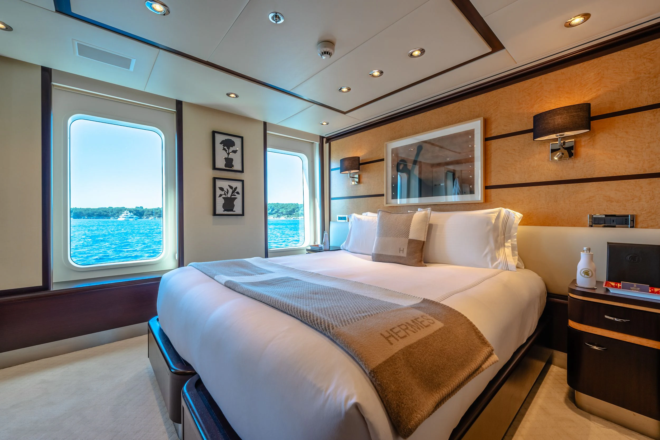 a bedroom with a bed and a desk aboard GLADIATOR Yacht for Sale
