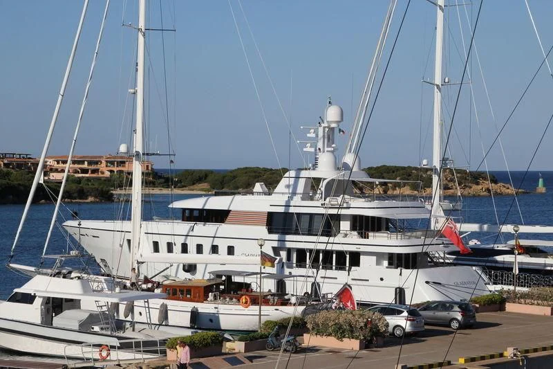 a large white boat sits in a harbor aboard GLADIATOR Yacht for Sale