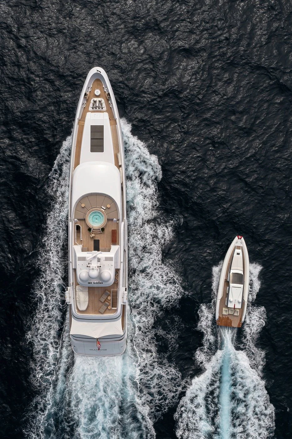 a white boat on a body of water aboard GLADIATOR Yacht for Sale