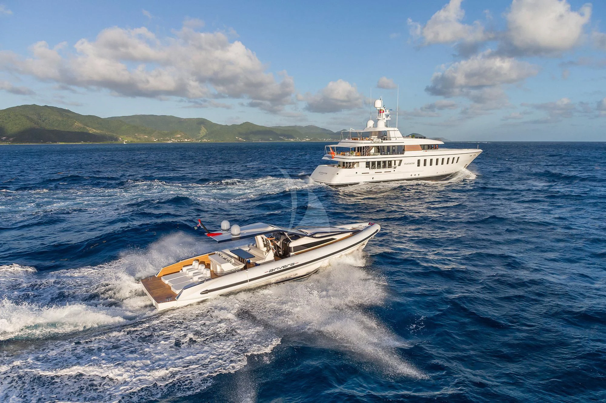 a boat and a motor boat in the water aboard GLADIATOR Yacht for Sale