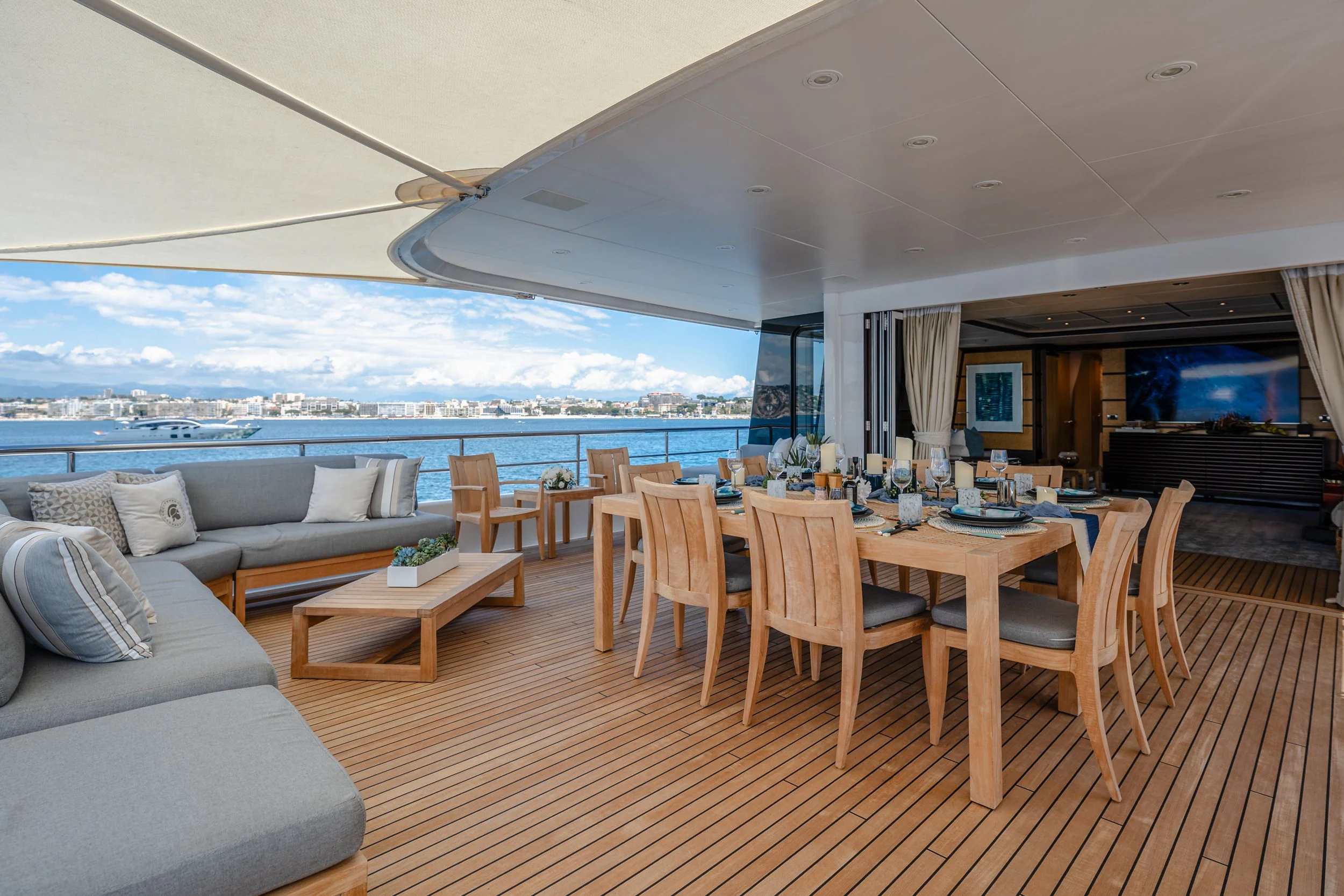 a living room with a table and couches aboard GLADIATOR Yacht for Sale