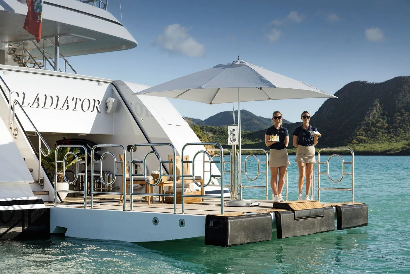 a couple of people standing on a boat aboard GLADIATOR Yacht for Sale