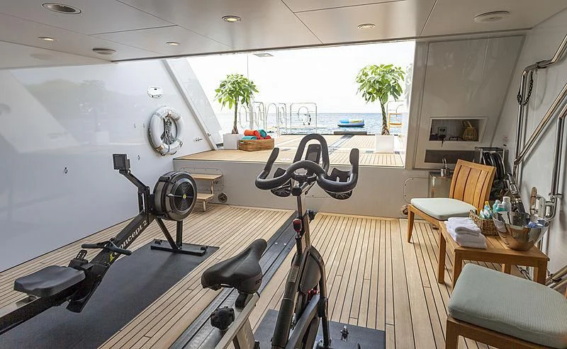 a room with a table chairs and a fan aboard GLADIATOR Yacht for Sale
