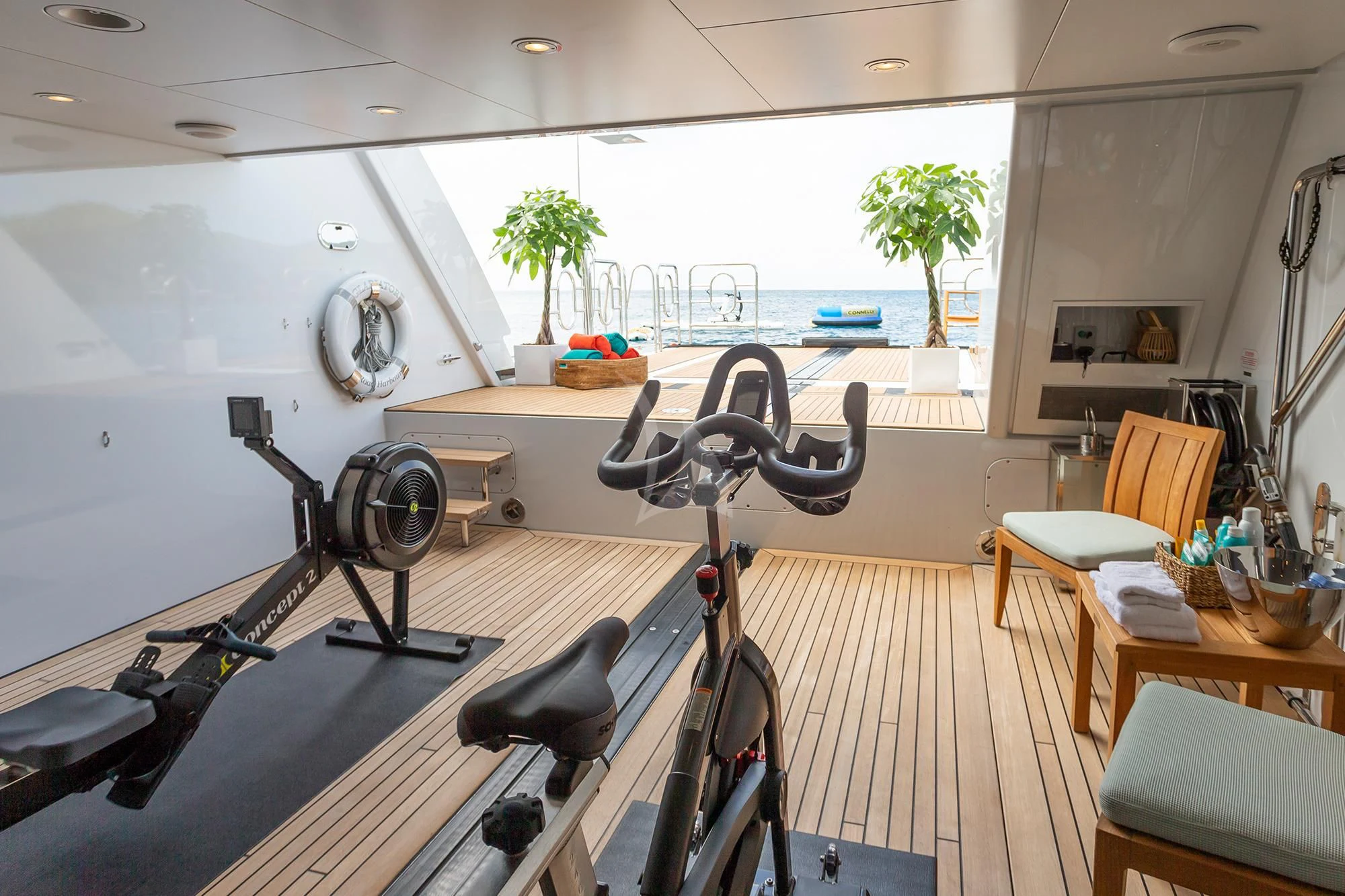 a room with tables and chairs aboard GLADIATOR Yacht for Sale
