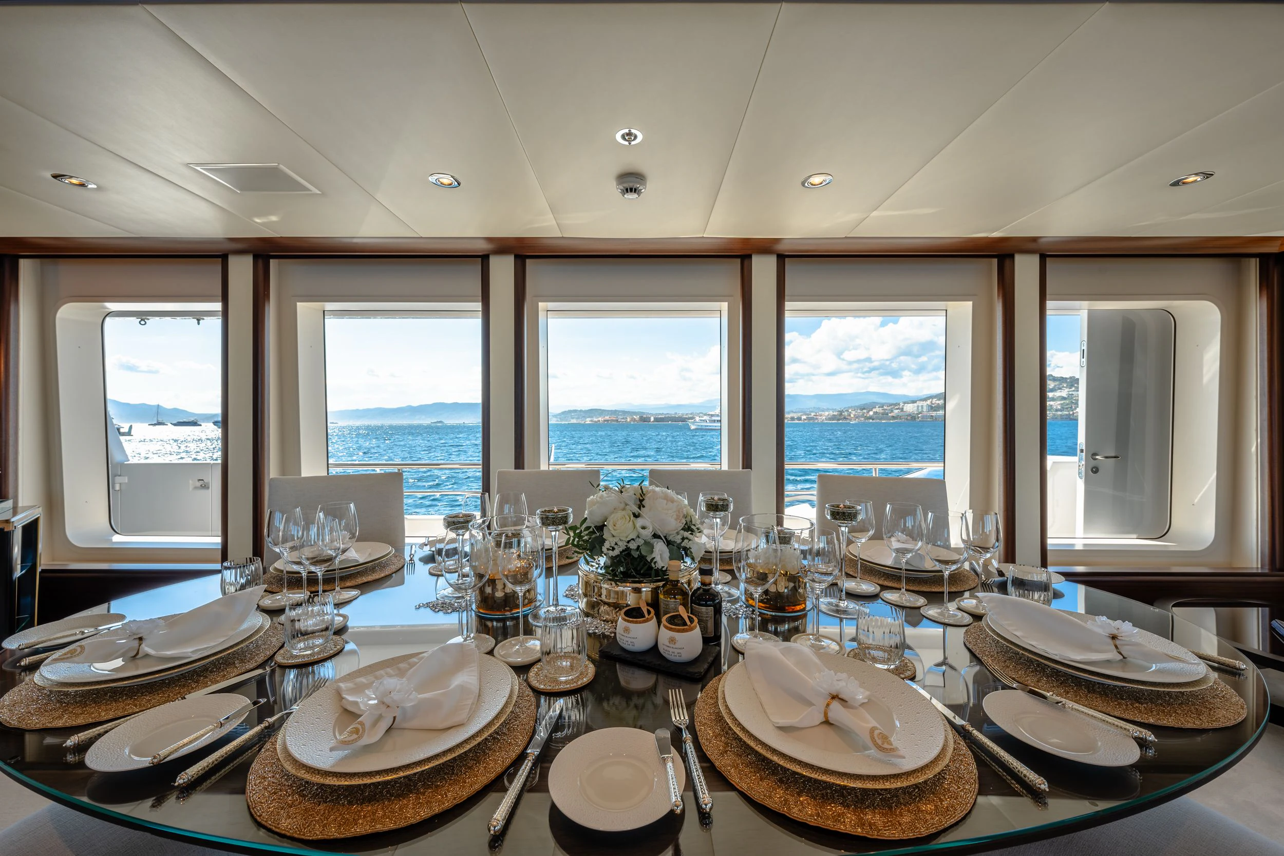 a table with plates and glasses on it aboard GLADIATOR Yacht for Sale