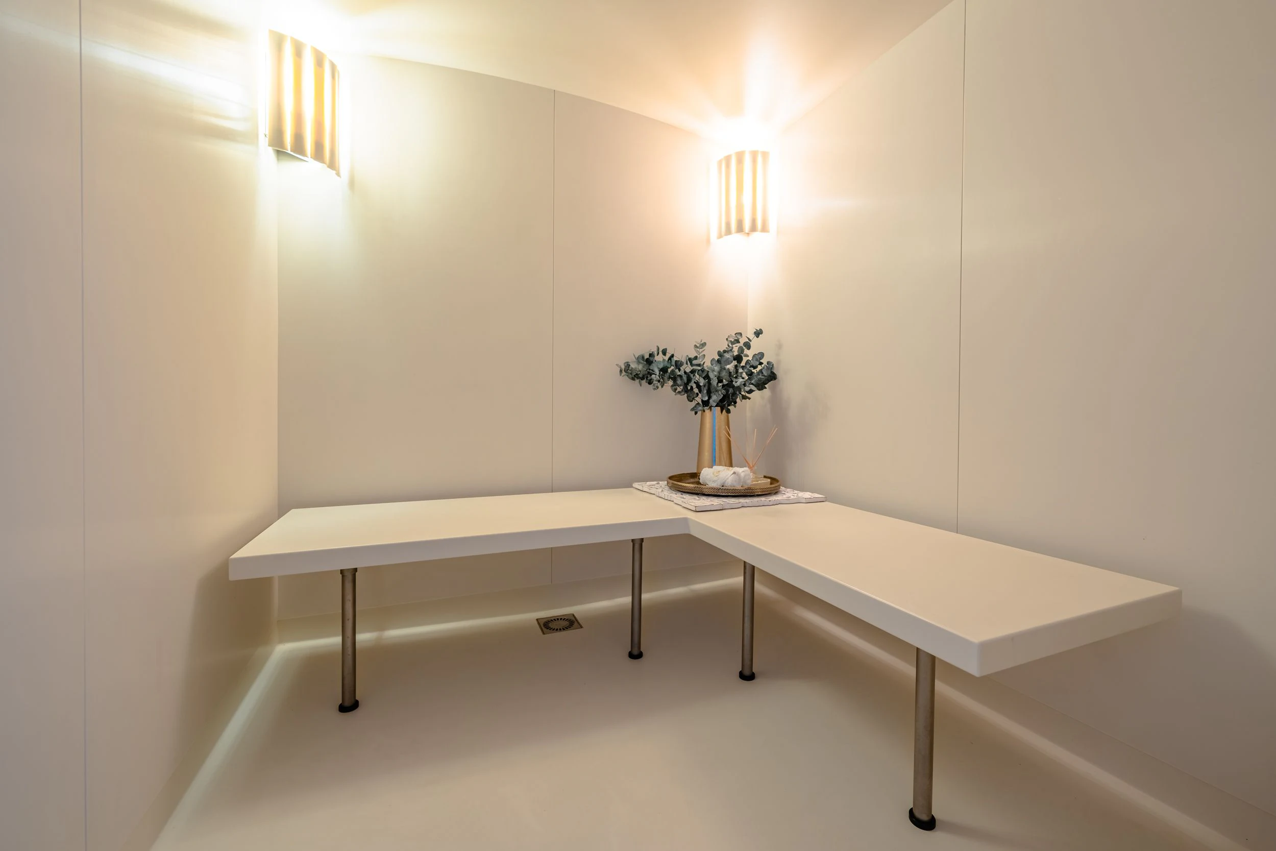 a white table with a plant on it aboard GLADIATOR Yacht for Sale