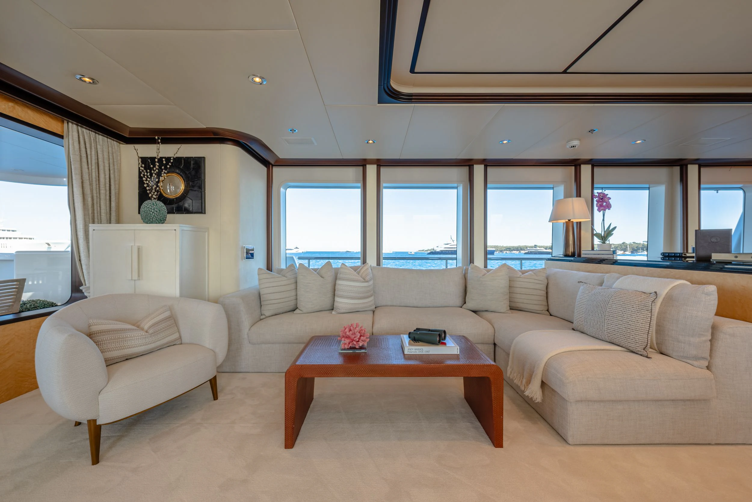 a living room with a couch and a coffee table aboard GLADIATOR Yacht for Sale
