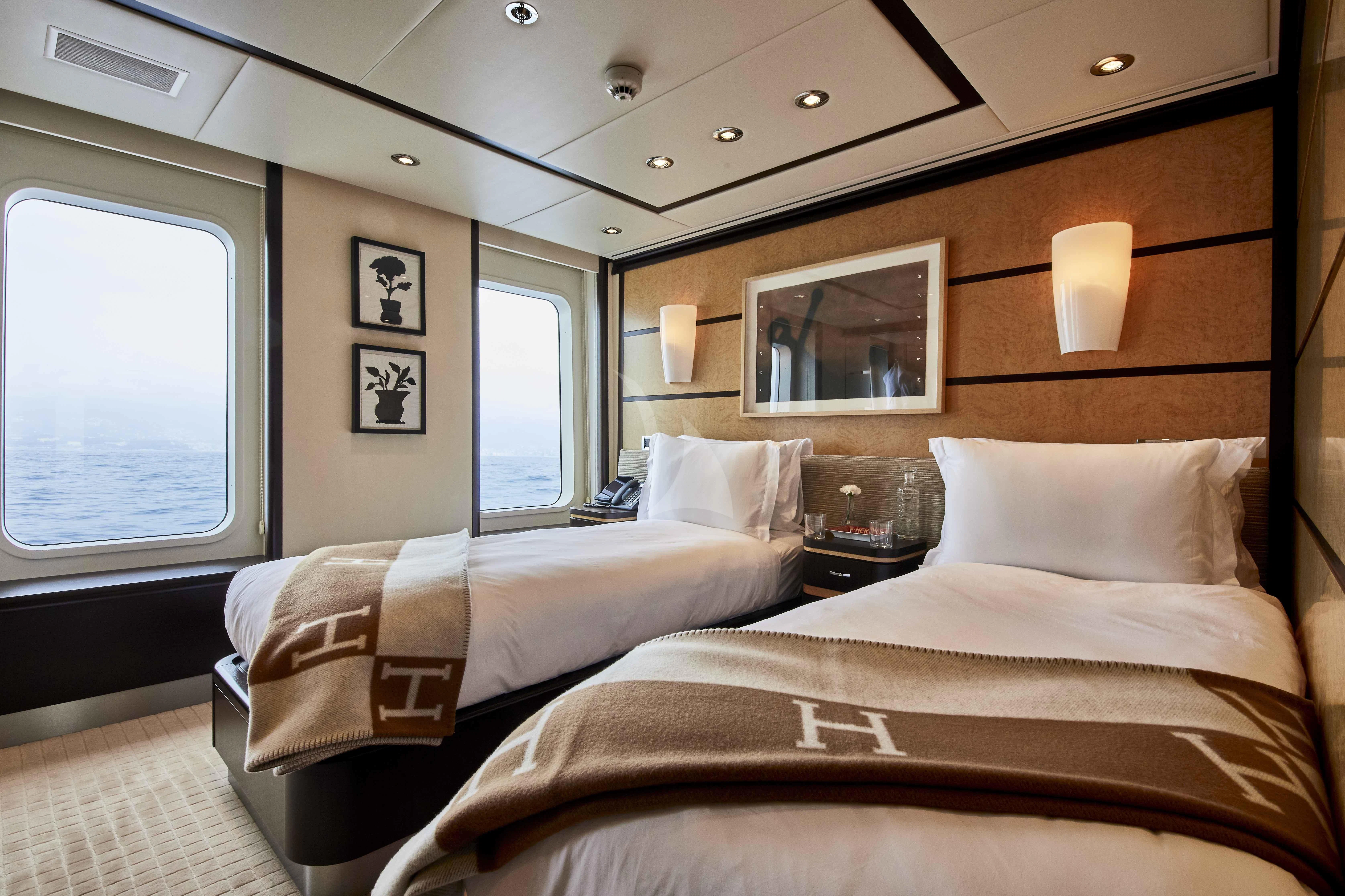 a couple of beds in a hotel room aboard GLADIATOR Yacht for Sale