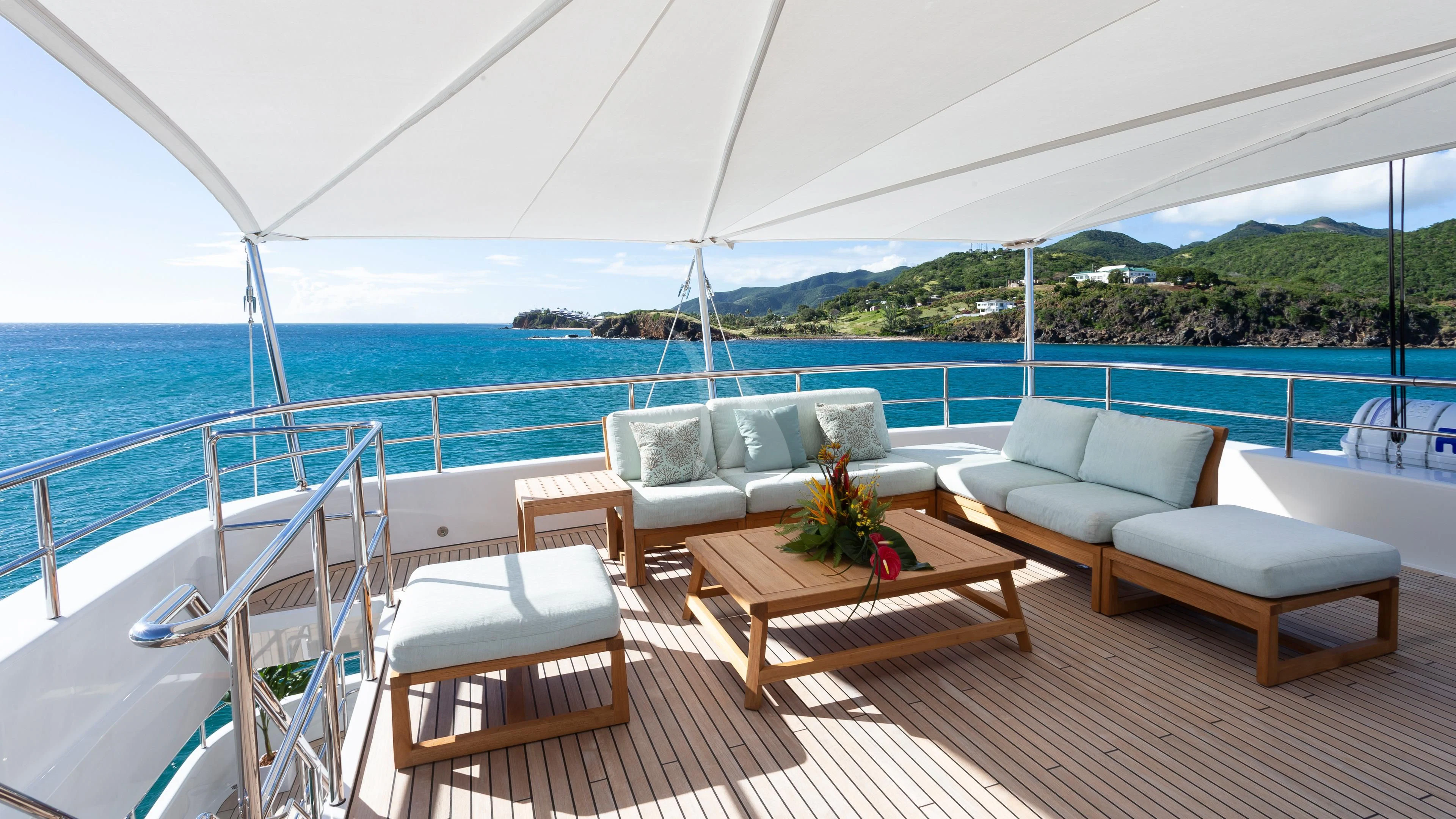 a deck with chairs and a table on it aboard GLADIATOR Yacht for Sale