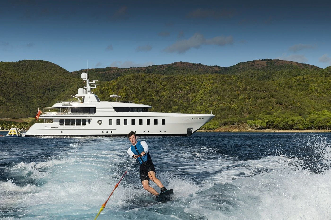 a man water skiing behind a boat aboard GLADIATOR Yacht for Sale